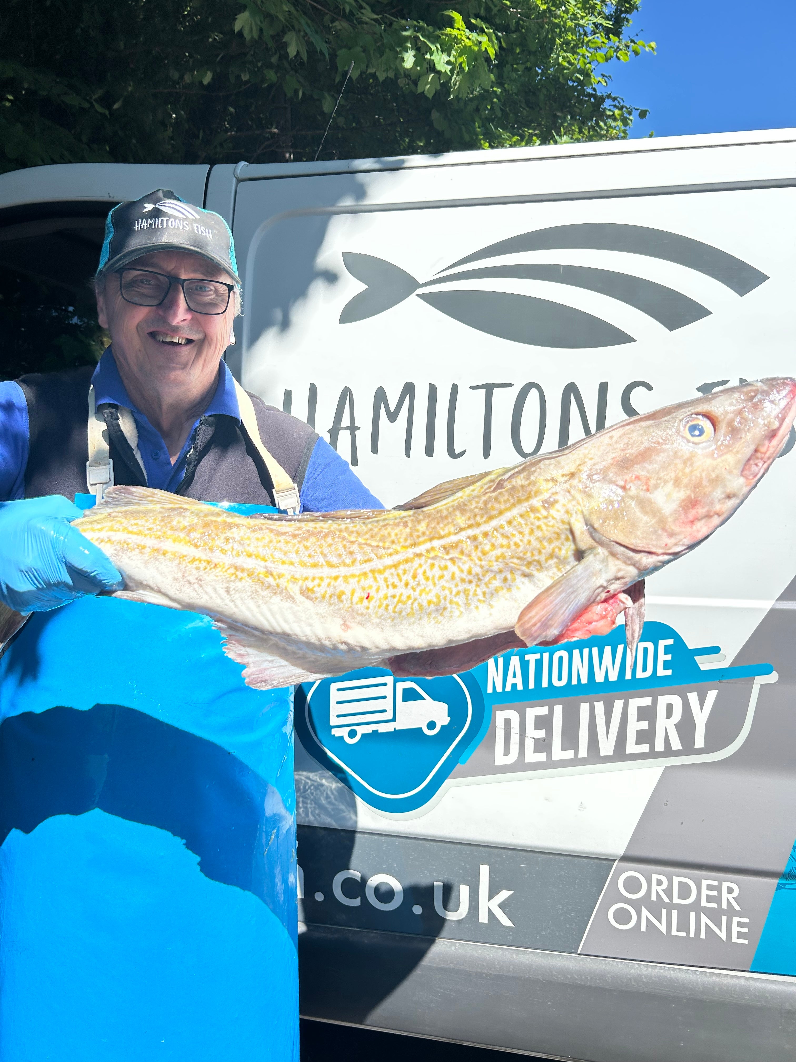 Kevin from hamiltons fish holding a large whole cod