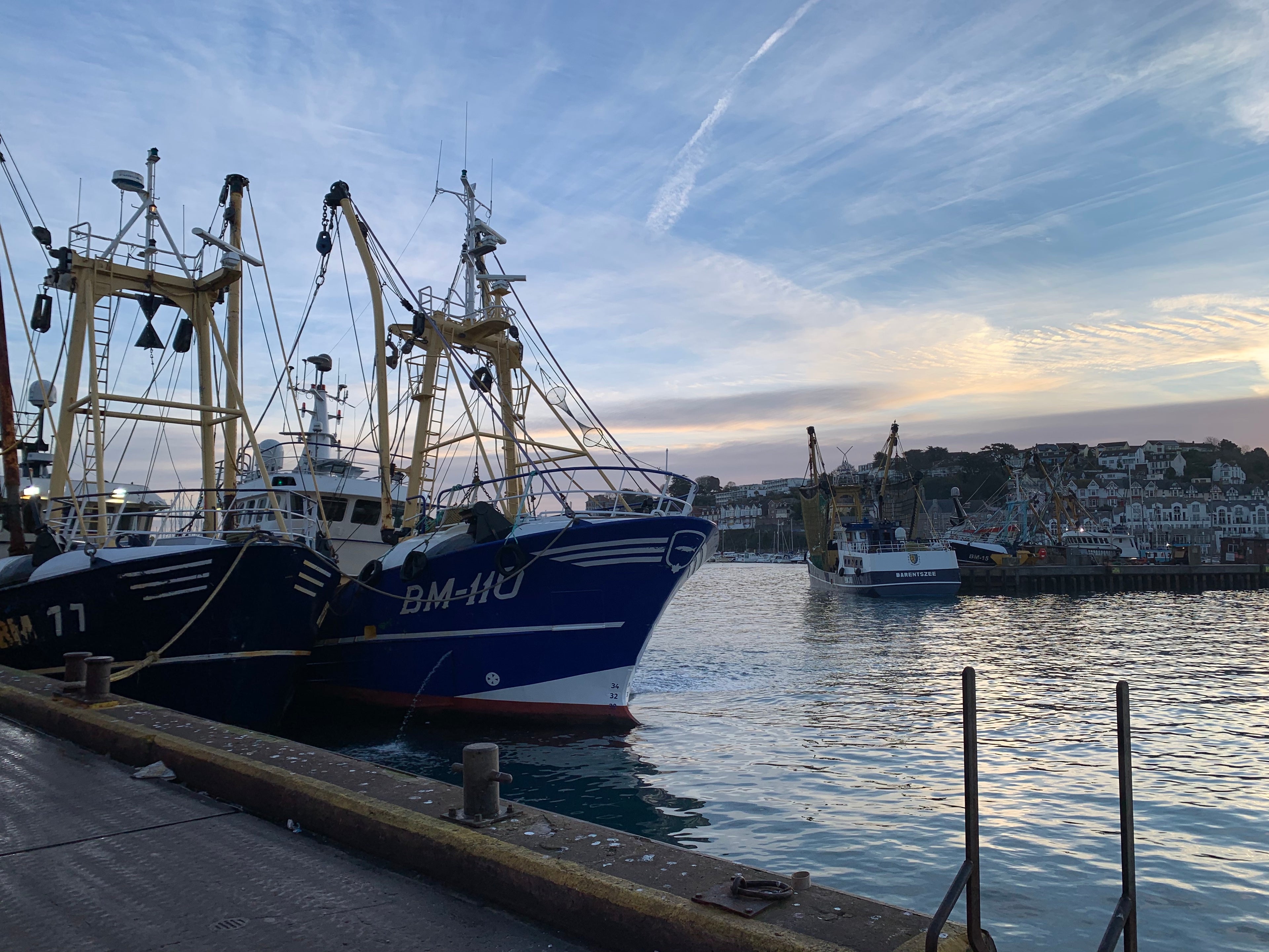 brixham fishing boats with brixham in the back ground