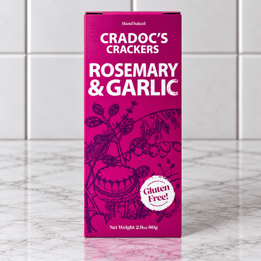 Cradoc’s Gluten Free Rosemary & Garlic Crackers (80g) on a slate background, from Hamiltons Fish