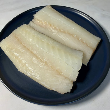 Fresh Wild Cod Fillets on a slate background, from Hamiltons Fish