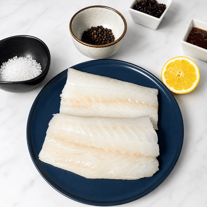 Fresh Wild Cod Fillets on a slate background, from Hamiltons Fish