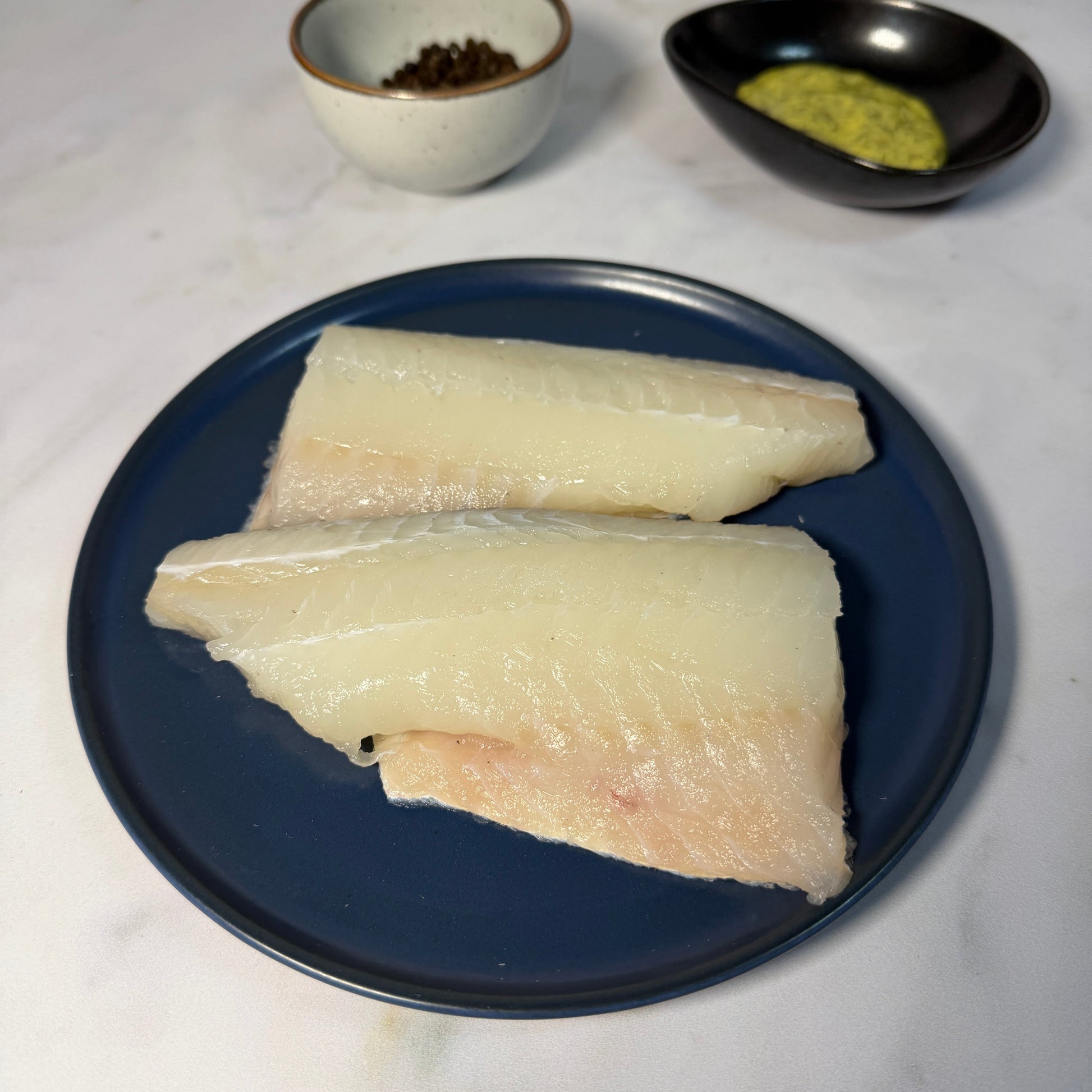 Fresh Wild Haddock Fillets on a slate background, from Hamiltons Fish