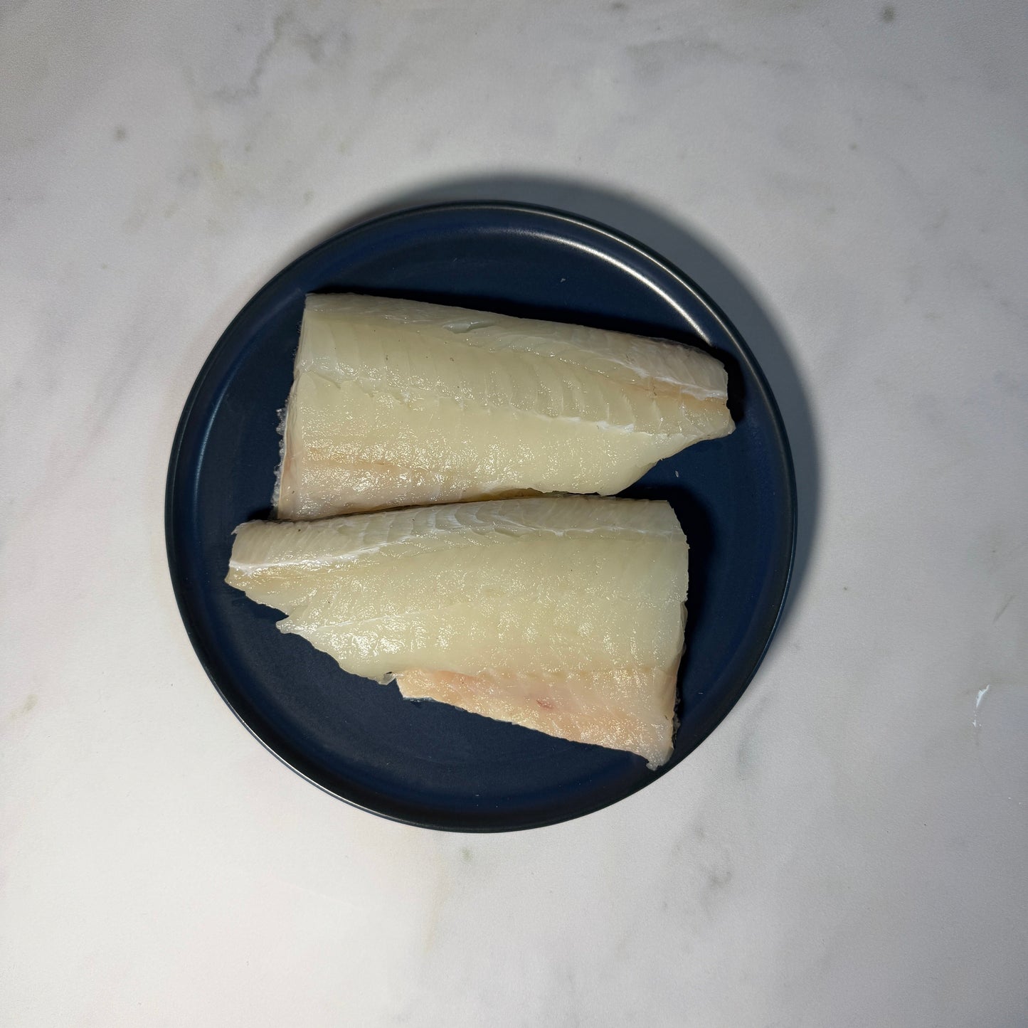 Fresh Wild Haddock Fillets on a slate background, from Hamiltons Fish