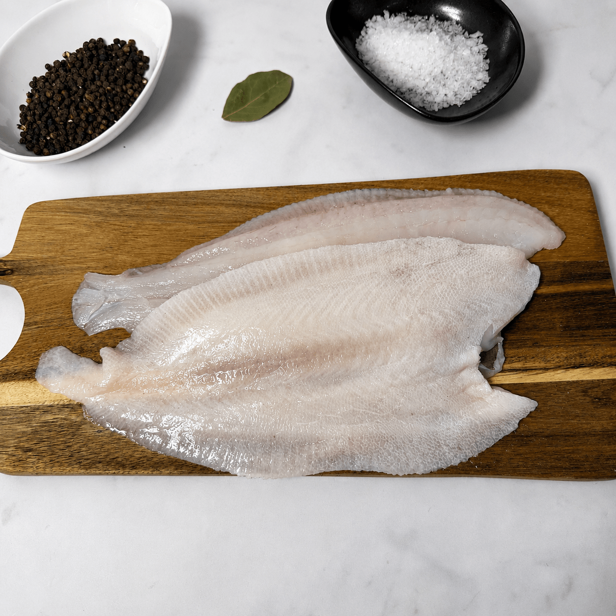 Fresh Wild Megrim Sole Fillets on a slate background, from Hamiltons Fish