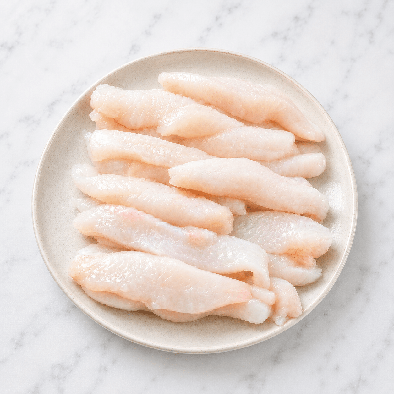 Fresh Wild Monkfish Goujons on a slate background, from Hamiltons Fish