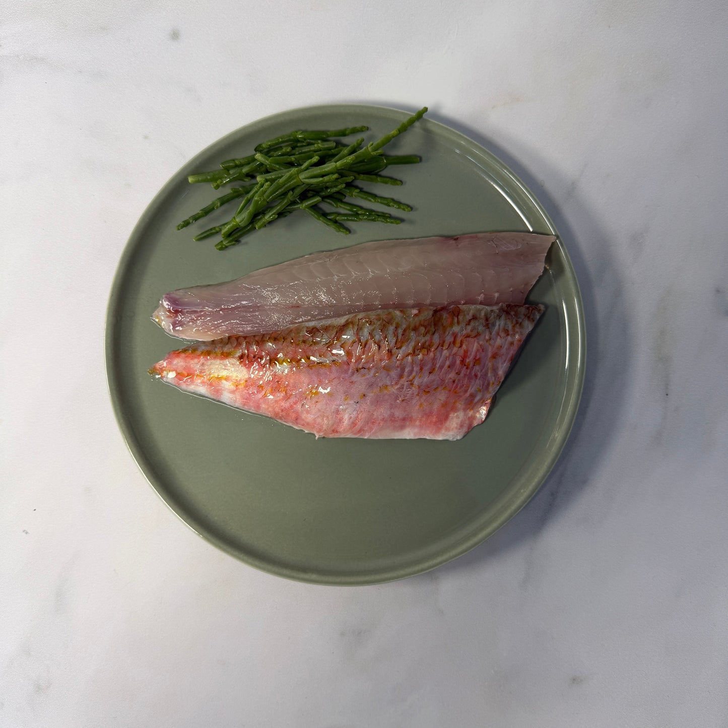 Fresh Wild Red Mullet Fillets on a slate background, from Hamiltons Fish