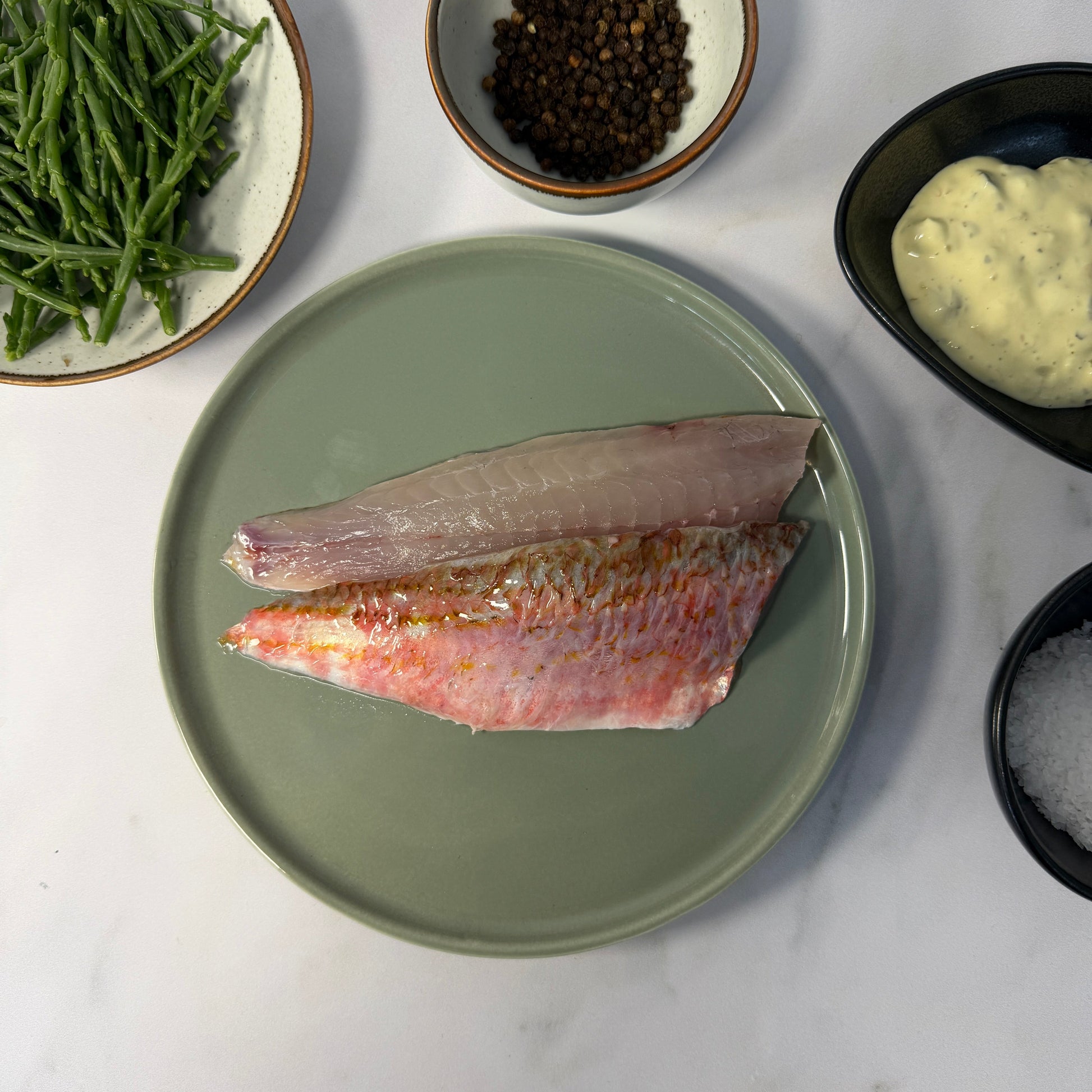 Fresh Wild Red Mullet Fillets on a slate background, from Hamiltons Fish
