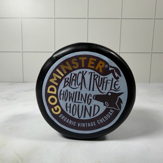 Godminster Black Truffle Howling Hound Cheddar (200g) on a slate background, from Hamiltons Fish