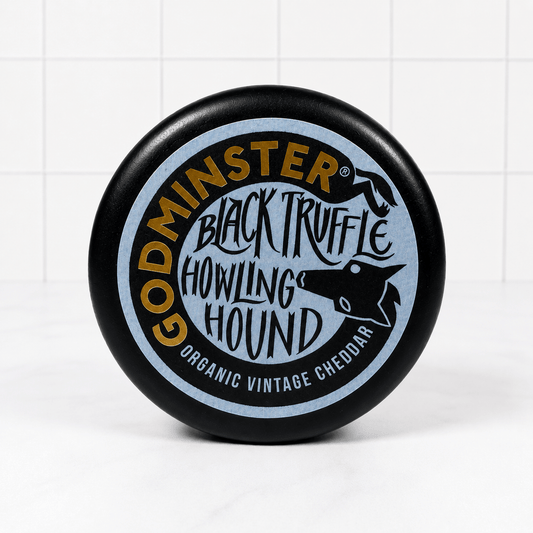 Godminster Black Truffle Howling Hound Cheddar (200g) on a slate background, from Hamiltons Fish