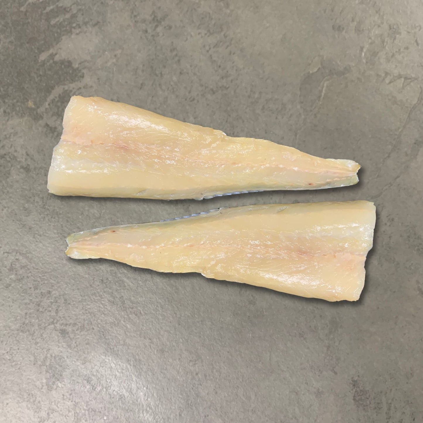 Natural Smoked Hake Fillets on a slate background, from Hamiltons Fish